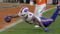 Buffalo Bills wide receiver Keon Coleman after getting tripped up stumbles towards the end zone and gets the ball into the end zone before hitting the ground for a touchdown during second half action at Empower FIeld at Mile High