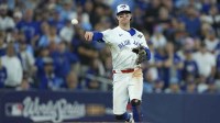 Toronto Blue Jays third baseman Ernie Clement (22) throws to first for an out against Los Angeles Dodgers second baseman Miguel Rojas (72) in the eleventh inning during game seven of the 2025 MLB World Series at Rogers Centre.