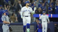 Toronto Blue Jays designated hitter Bo Bichette (11) reacts after hitting a three run home run against the Los Angeles Dodgers in the third inning during game seven of the 2025 MLB World Series at Rogers Centre