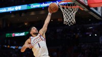 Phoenix Suns guard Devin Booker (1) dunks against the Miami Heat during the third quarter at Kaseya Center.