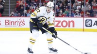 Boston Bruins defenseman Hampus Lindholm (27) looks to pass the puck against the Chicago Blackhawks during the second period at United Center.