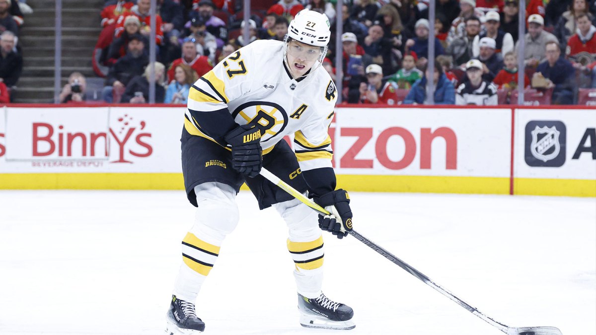 Boston Bruins defenseman Hampus Lindholm (27) looks to pass the puck against the Chicago Blackhawks during the second period at United Center.