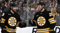 Boston Bruins center Elias Lindholm (28) celebrates with center Pavel Zacha (18) after scoring a goal against the Vegas Golden Knights during the first period at the TD Garden.