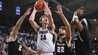 Gonzaga Bulldogs forward Braden Huff (34) shoots the ball against Santa Clara Broncos guard Sash Gavalyugov (2) and Santa Clara Broncos forward Allen Graves (22) in the first half at McCarthey Athletic Center.