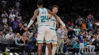 Charlotte Hornets forward Brandon Miller (24) and guard LaMelo Ball (1) high five after a dunk and assist during the second half against the Detroit Pistons at Spectrum Center.