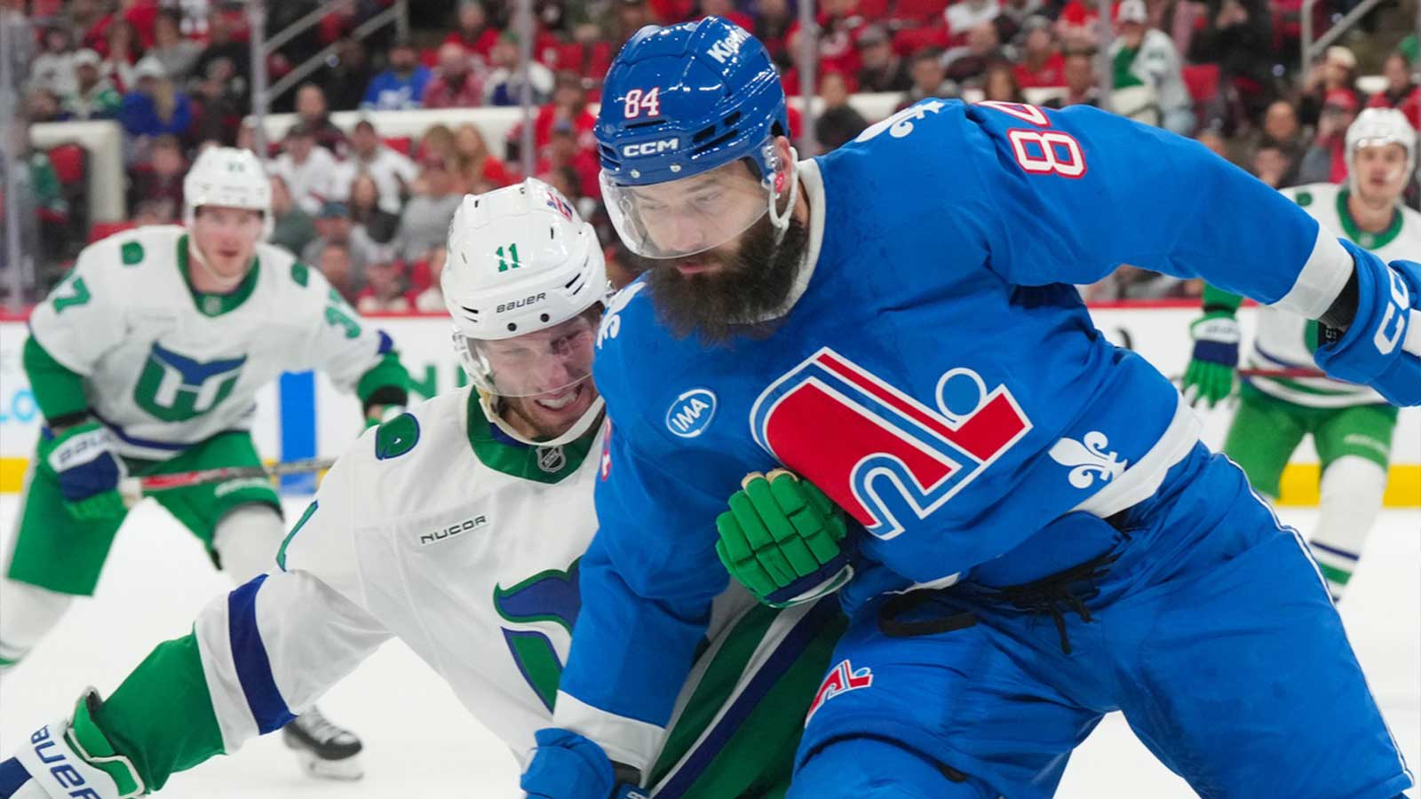 Colorado Avalanche defenseman Brent Burns (84) and Carolina Hurricanes center Jordan Staal (11) battle during the third period at Lenovo Center.