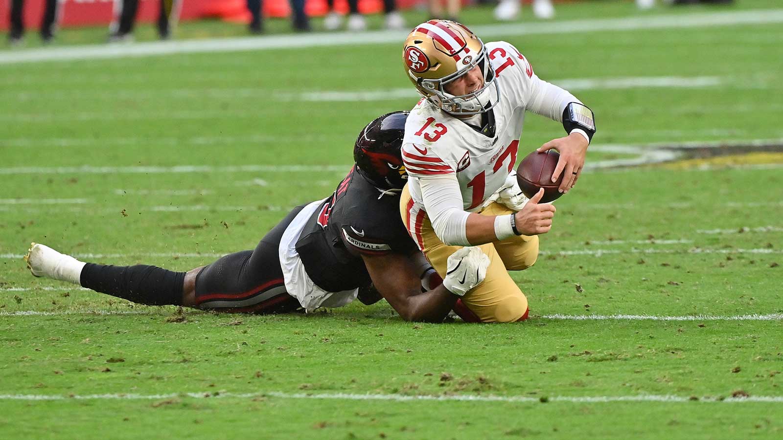 San Francisco 49ers quarterback Brock Purdy (13) is sacked by Arizona Cardinals outside linebacker Josh Sweat (10) in the third quarter at State Farm Stadium.