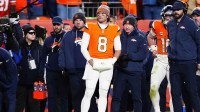 Denver Broncos quarterback Jarrett Stidham (8) stands next to quarterback Bo Nix (10)) during overtime of an AFC Divisional Round playoff game against the Buffalo Bills at Empower Field at Mile High