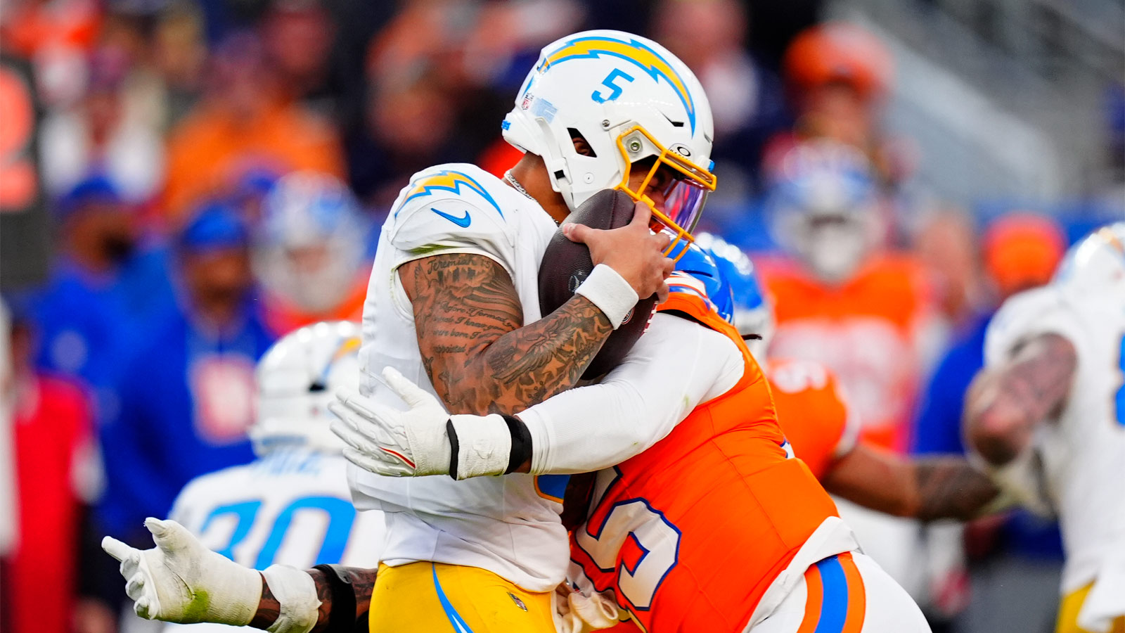 Denver Broncos running back J.K. Dobbins (27) rushes the ball against the Las Vegas Raiders during the first half at Empower Field at Mile High