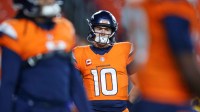 Denver Broncos quarterback Bo Nix (10) looks on during warmups prior to the game against the Washington Commanders at Northwest Stadium.
