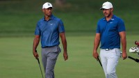 Tiger Woods (left) walks with Brooks Koepka (right) towards the 13th green during the second round of The Memorial Tournament at Muirfield Village Golf Club.