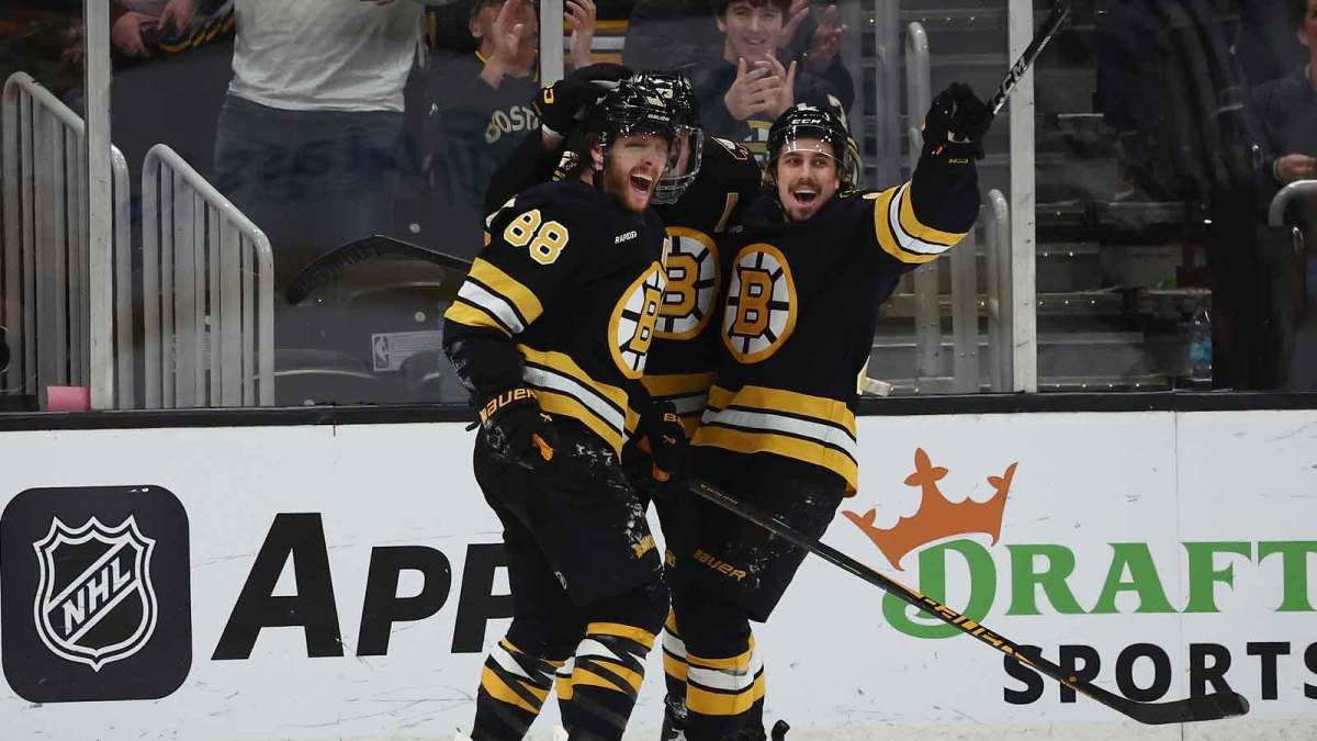 Boston Bruins right wing David Pastrnak (88) celebrates with center Marat Khusnutdinov (92) after scoring the winning goal in overtime against the Nashville Predators at TD Garden.