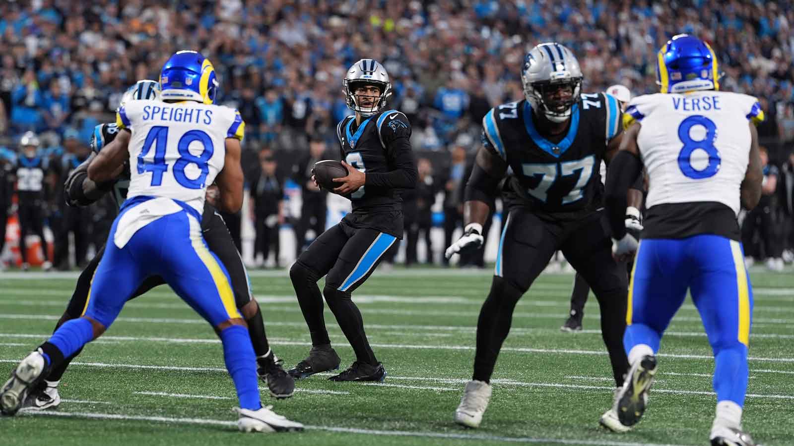 Carolina Panthers quarterback Bryce Young (9) drops back to pass against the Los Angeles Rams in the first half during the NFC Wild Card Round game at Bank of America Stadium.