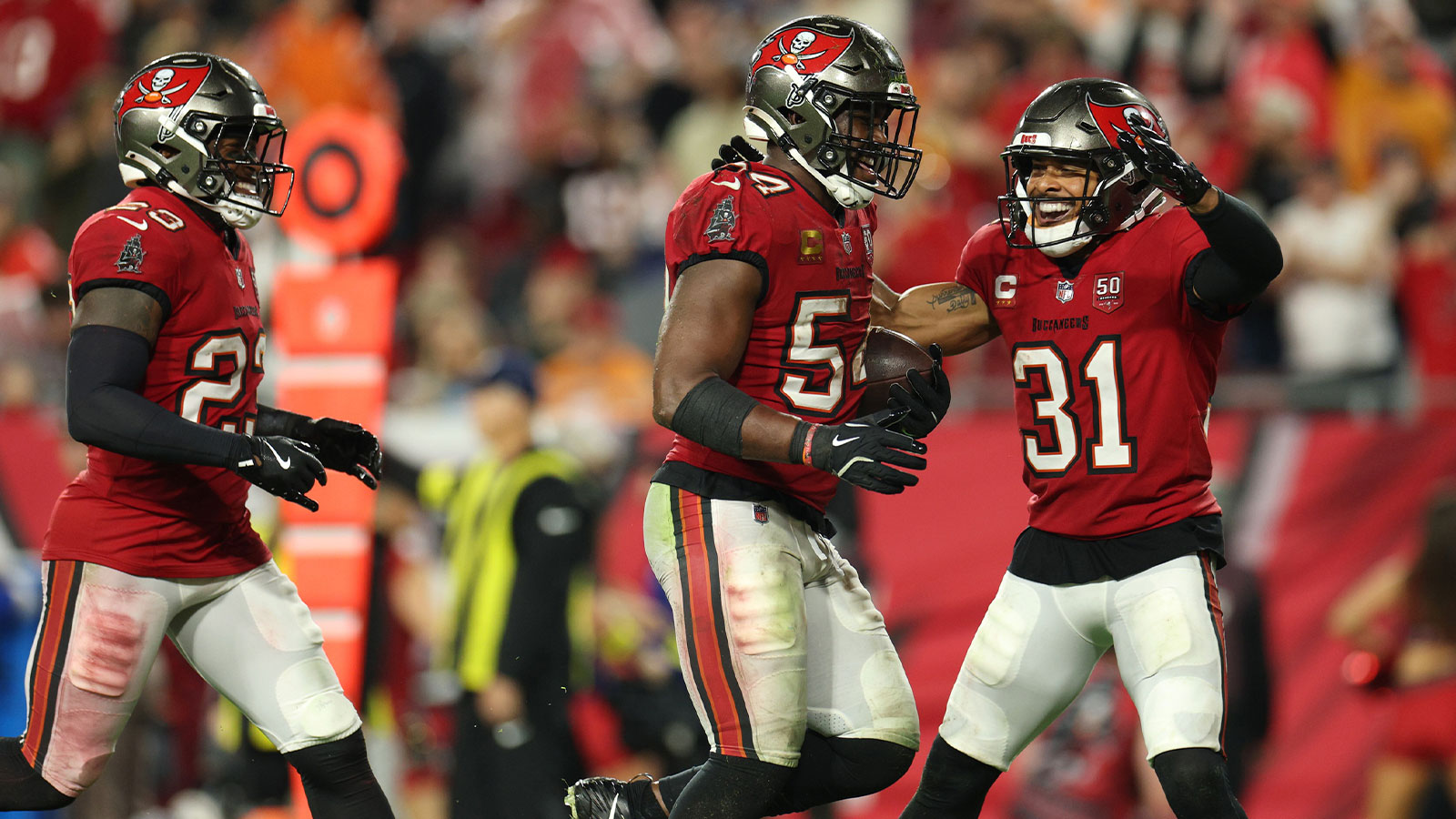 Tampa Bay Buccaneers linebacker Lavonte David (54) celebrates with safety Antoine Winfield Jr. (31) and safety Tykee Smith (23) after recovering a fumble by the Carolina Panthers in the second half at Raymond James Stadium.