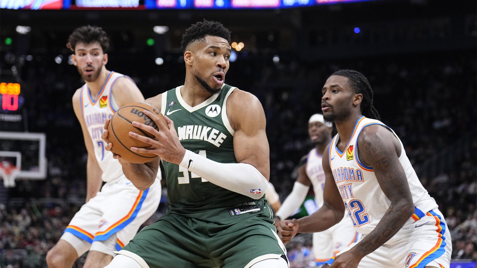 Bucks forward Giannis Antetokounmpo (34) drives to the basket against Oklahoma City Thunder guard Cason Wallace (22) in the second half at Fiserv Forum