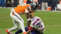 Denver Broncos cornerback Ja'quan McMillian reaches in on Buffalo Bills wide receiver Brandin Cooks who has the ball and whose knee is on the ground during overtime at Empower FIeld at Mile High in Denver, Colorado on Jan. 17, 2026.