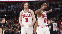 Bulls guard Josh Giddey (3) and guard Coby White (0) celebrate a defensive stop against the Washington Wizards during the second half at United Center