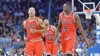 Bulls guard Derrick Rose reacts with Luol Deng