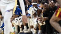 Golden State Warriors forwards Al Horford (from left) Jimmy Butler III (10) and guard Stephen Curry (30) watch as the second team plays out the closing minutes of the fourth quarter against the Atlanta Hawks at Chase Center.