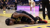 Golden State Warriors forward Jimmy Butler III (10) holds his right knee as he goes down with an injury during the third quarter against the Miami Heat at Chase Center.