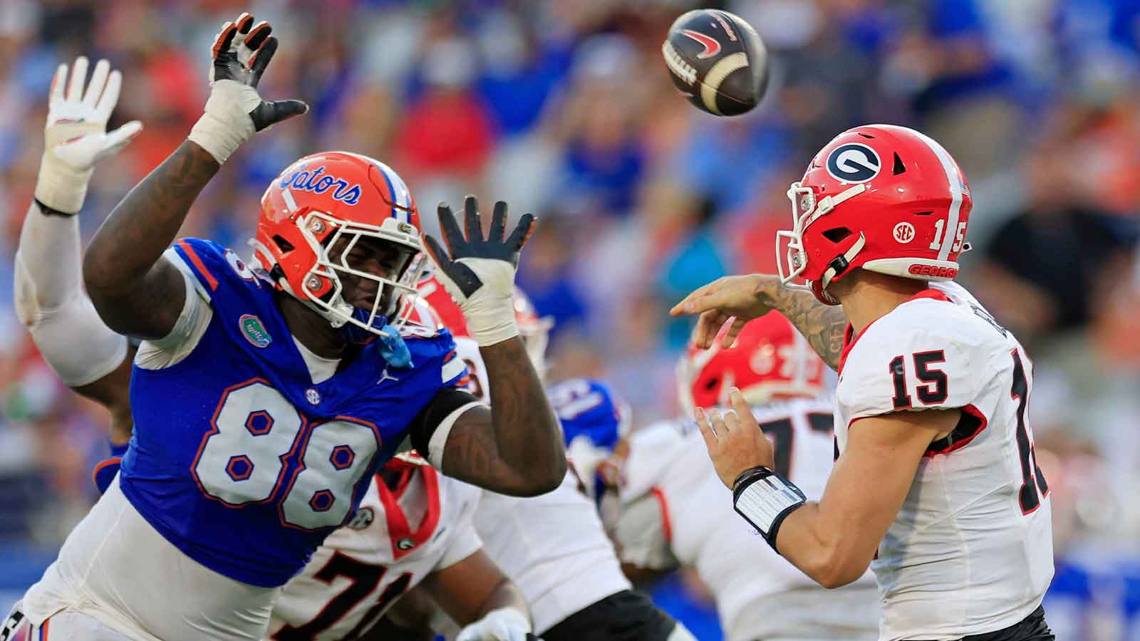 Georgia Bulldogs quarterback Carson Beck (15) is pressured by Florida Gators defensive lineman Caleb Banks (88) during the third quarter of an NCAA football game Saturday, Oct. 28, 2023 at EverBank Stadium in Jacksonville, Fla. Georgia defeated Florida 43-20.