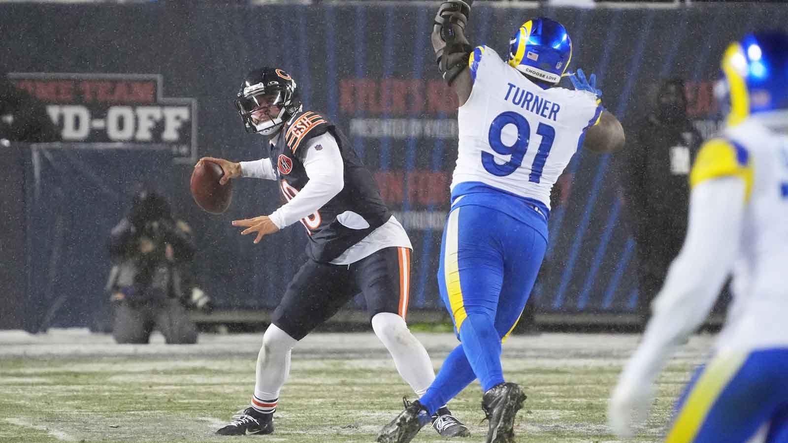 Chicago Bears quarterback Caleb Williams (18) throws a pass against Los Angeles Rams defensive end Kobie Turner (91) during the third quarter of an NFC Divisional Round game at Soldier Field.