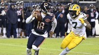 Chicago Bears quarterback Caleb Williams (18) rolls out as Green Bay Packers linebacker Quay Walker (7) applies the pressure during the first half of an NFC Wild Card Round game at Soldier Field. Mandatory Credit: Matt Marton-Imagn Images
