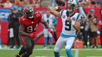 Carolina Panthers quarterback Bryce Young (9) throws the ball as Tampa Bay Buccaneers defensive tackle Calijah Kancey (94) rushes during the second quarter at Raymond James Stadium.
