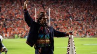 Former Auburn quarterback Cam Newton cheers on his team from the sideline as Auburn Tigers take on Georgia Bulldogs at Jordan-Hare Stadium in Auburn, Ala. on Saturday, Oct. 11, 2025. Auburn Tigers lead Georgia Bulldogs 10-3 at halftime.