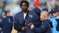 Tennessee Titans quarterback Cam Ward (1) stands on the sidelines with his right arm in a sling during the third quarter after a shoulder injury against the Jacksonville Jaguars in the first half at EverBank Stadium.