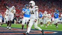 Miami Hurricanes quarterback Carson Beck (11) rushes for a touchdown against the Mississippi Rebels in the second half during the 2026 Fiesta Bowl and semifinal game of the College Football Playoff at State Farm Stadium.
