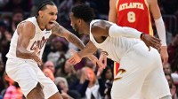 Cleveland Cavaliers guard Jaylon Tyson (20) celebrates with Cleveland Cavaliers guard Donovan Mitchell (45) during the first half against the Atlanta Hawks at Rocket Arena.