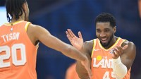 Cleveland Cavaliers guard Jaylon Tyson (20) and guard Donovan Mitchell (45) celebrate in the first quarter against the Orlando Magic at Rocket Arena.