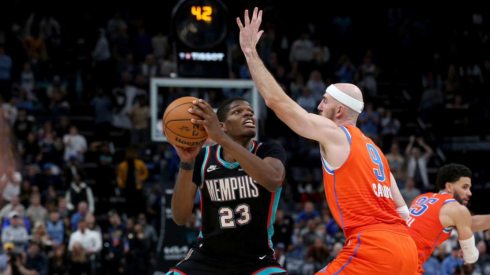Memphis Grizzlies forward Cedric Coward (23) looks for an open shot in the final seconds of the the fourth quarter as Oklahoma City Thunder guard Alex Caruso (9) defends at FedExForum.