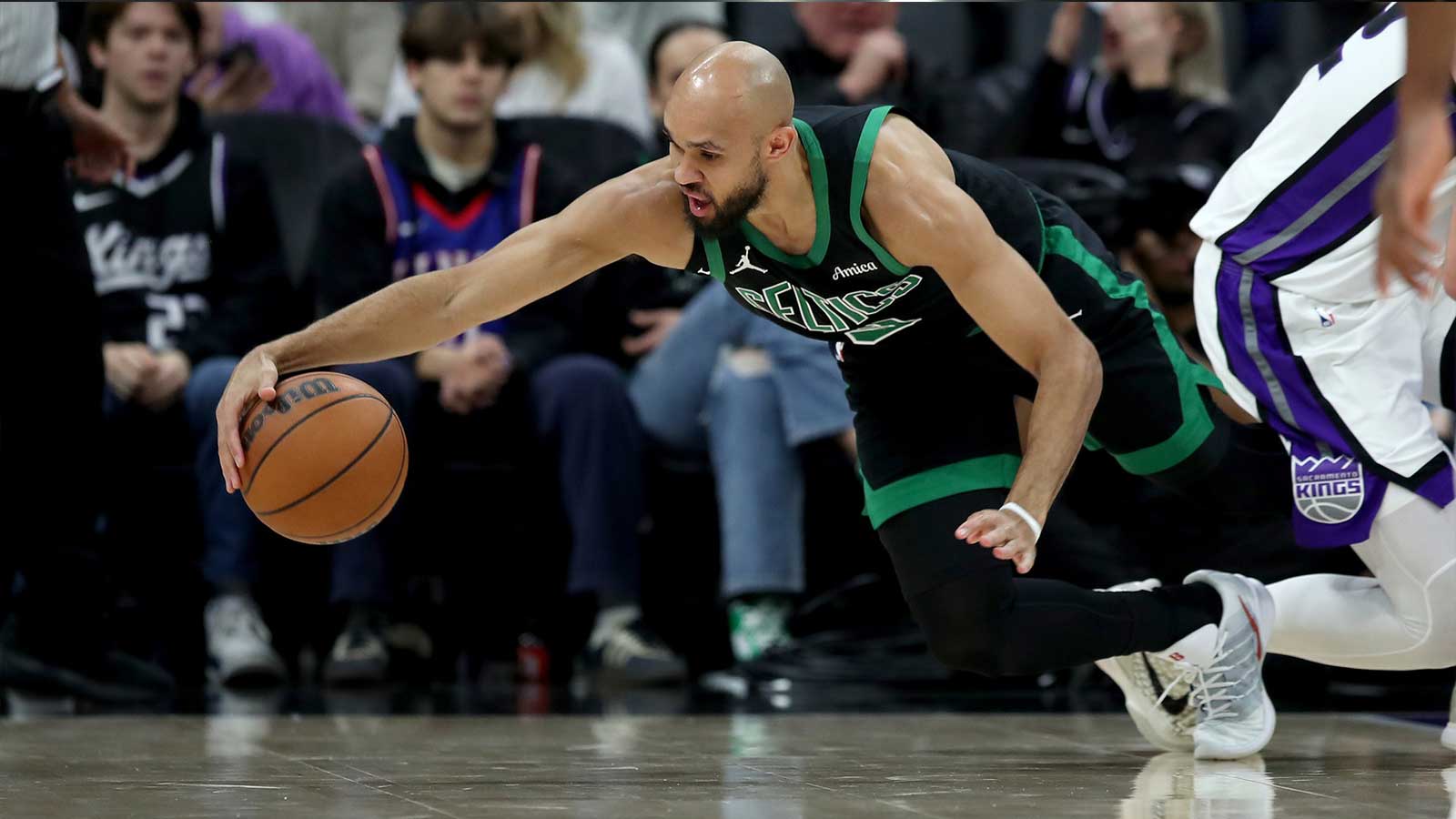 Boston Celtics guard Derrick White (9) dives for a loose ball against the Sacramento Kings during the second quarter at Golden 1 Center. 