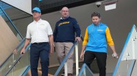 Los Angeles Chargers coach Jim Harbaugh (left), general manager Joe Hortiz (center) and senior vice president of communications and brand messaging Josh Rupprecht arrive at press conference at The Bolt. Mandatory Credit: Kirby Lee-Imagn Images