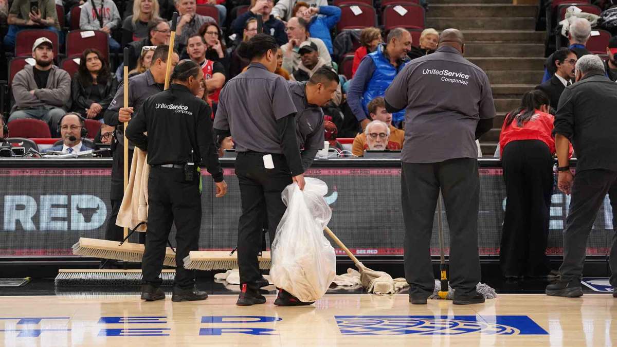 Jan 8, 2026; Chicago, Illinois, USA; United Center employees mop the court. The game between the Chicago Bulls and the Miami Heat is delayed because of condensation on the floor due to rain and humidity at United Center. Mandatory Credit: David Banks-Imagn Images