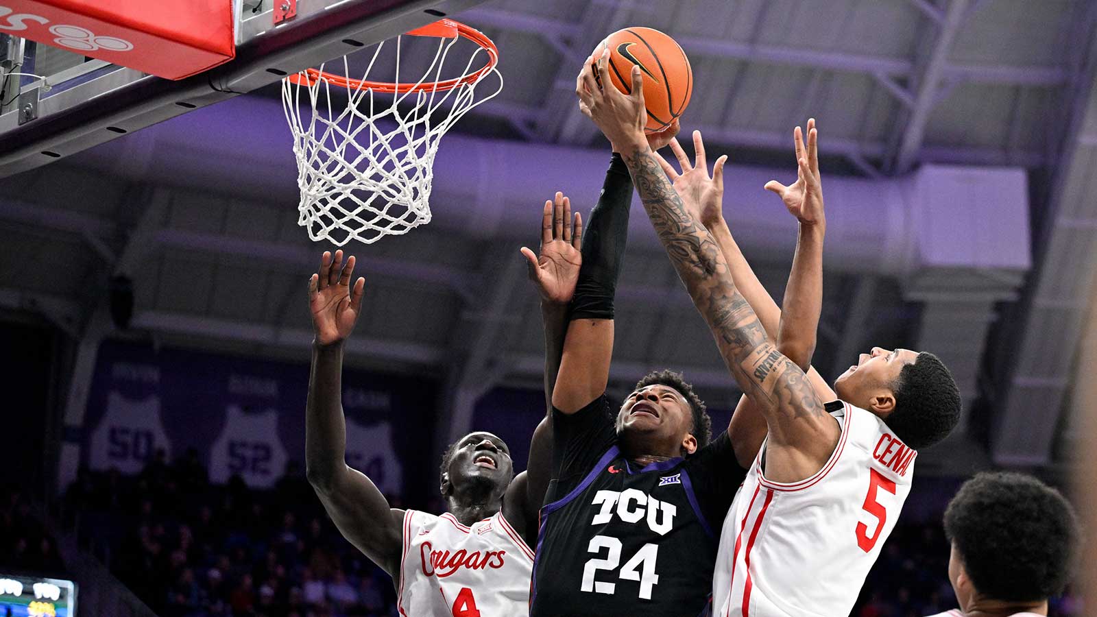 Houston Cougars forward Kalifa Sakho (14) and forward Chris Cenac Jr. (5) and TCU Horned Frogs forward Xavier Edmonds (24) battle for the rebound during the first half at Ed and Rae Schollmaier Arena.
