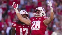 Wisconsin Badgers linebacker Christian Alliegro (28) celebrates with linebacker Darryl Peterson (17) during the fourth quarter against the South Dakota Coyotes at Camp Randall Stadium.