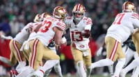 San Francisco 49ers quarterback Brock Purdy (13) hands off the ball to running back Christian McCaffrey (23) against the Philadelphia Eagles during the second quarter in an NFC Wild Card Round game at Lincoln Financial Field.