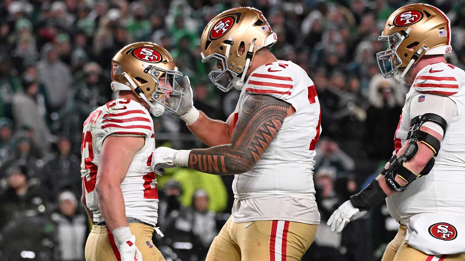 San Francisco 49ers running back Christian McCaffrey (23) celebrates his touchdown catch with guard Spencer Burford (74) against the Philadelphia Eagles during the fourth quarter in an NFC Wild Card Round game at Lincoln Financial Field.