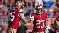 San Francisco 49ers running back Christian McCaffrey (23) is congratulated by tight end George Kittle (85) after scoring a touchdown against the Tampa Bay Buccaneers during the first quarter at Levi's Stadium.