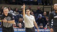 Cincinnati Bearcats head coach Wes Miller points during the first half against the West Virginia Mountaineers at Hope Coliseum.
