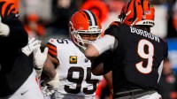 Cincinnati Bengals quarterback Joe Burrow (9) is pursued by Cleveland Browns defensive end Myles Garrett (95) in the first quarter of the NFL Week 18 game between the Cincinnati Bengals and the Cleveland Browns at Paycor Stadium in Downtown Cincinnati on Sunday, Jan. 4, 2026.