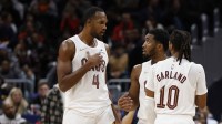 Cleveland Cavaliers guard Donovan Mitchell (45) talks with Cavaliers center Evan Mobley (4) and Cavaliers guard Darius Garland (10) during a stoppage in play against the Washington Wizards in the second half at Capital One Arena.