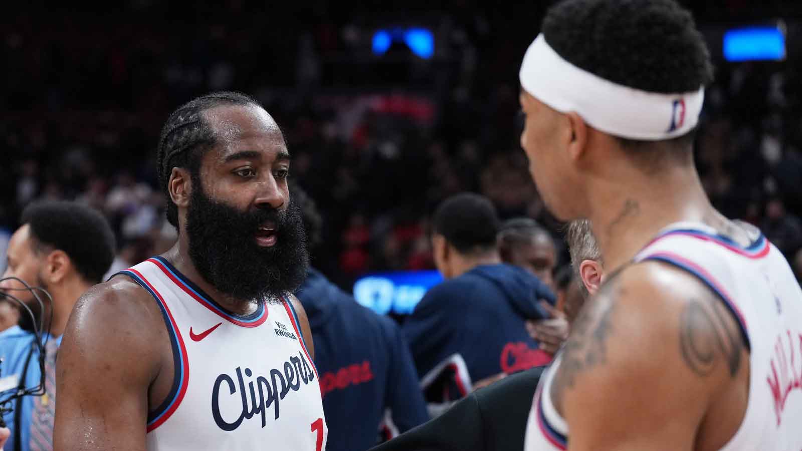 Clippers guard James Harden (1) celebrates the win with guard Jordan Miller (22) against the Toronto Raptor at the end of the overtime period at Scotiabank Arena