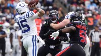 Indianapolis Colts quarterback Riley Leonard (15) throws downfield as Houston Texans defensive end Will Anderson Jr. (51) applies the pressure during the first half at NRG Stadium.