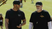 Washington Commanders general manager Adam Peters (L) talks with Commanders head coach Dan Quinn (R) while walking off the practice field on day two of training camp at OrthoVirginia Training Center at Commanders Park.