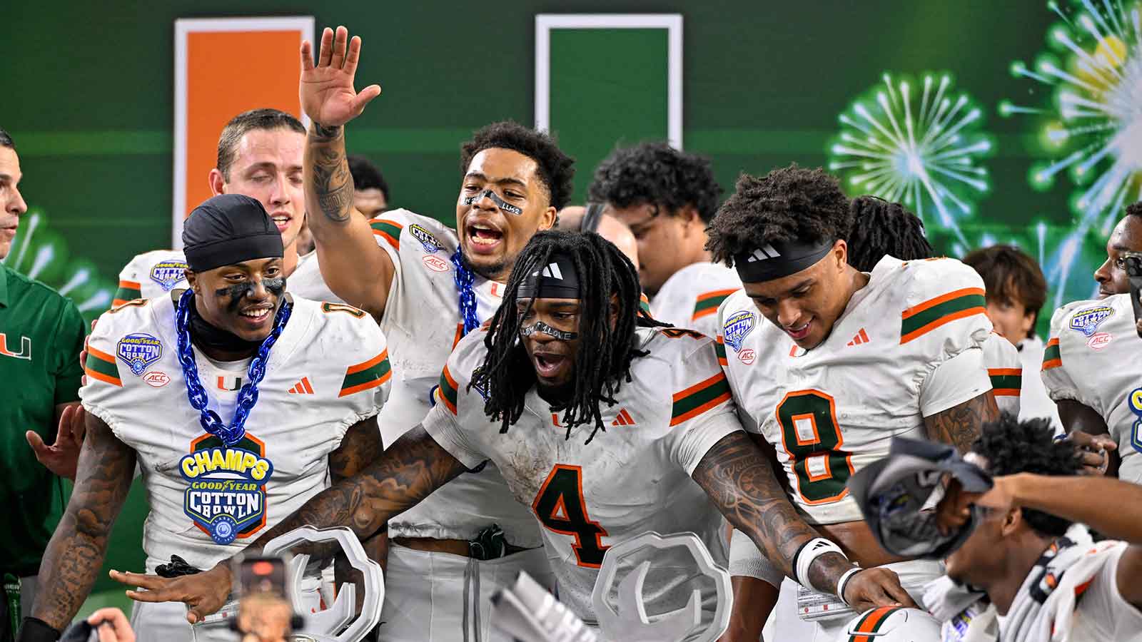 Miami Hurricanes defensive back Keionte Scott (0) and running back Mark Fletcher Jr. (4) and defensive back Jakobe Thomas (8) celebrate after the 2025 Cotton Bowl and quarterfinal game of the College Football Playoff at AT&T Stadium.