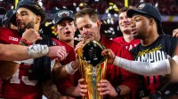 Indiana Head Coach Curt Cignetti prepares to lift the trophy on the podium after the College Football Playoff National Championship college football game at Hard Rock Stadium in Miami Gardens on Monday, Jan. 19, 2026.